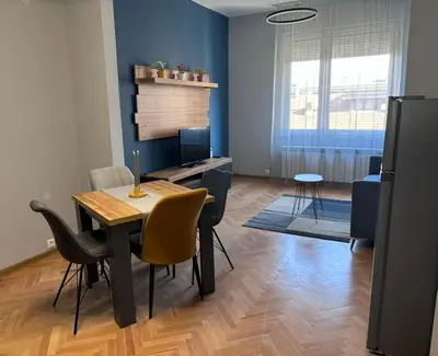 a living room with a dining room table and chairs at Боко 16-18 in Sofia