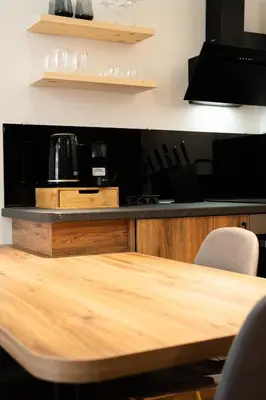 a table and chairs in a kitchen with a counter at Host2U Highland Hideaway Bansko in Bansko