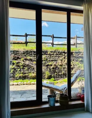 a window in a room with a view of a yard at Host2U Art AP - Fireplace - Free parking - 5min Gondola in Bansko