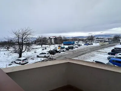 a view of a parking lot with cars in the snow at Host2U Belvedere Apartment - Ski in - out - FREE Parking in Bansko