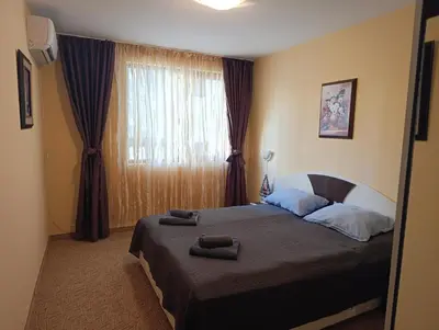 a bedroom with a bed with two towels on it at Снежна приказка Пампорово в хотел Mountain Lodge ап 29 in Pamporovo