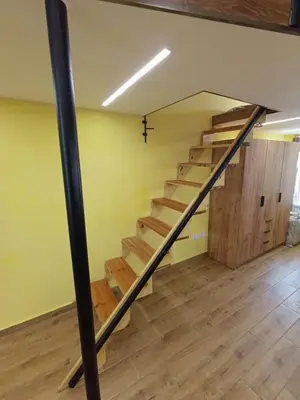 a staircase in a loft with wooden floors at Tranquility Lodge, next to Paradise and metro station in Sofia