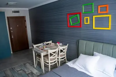 a bedroom with a table and chairs and a bed at HD Comfort Apartment in Sofia