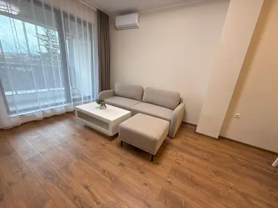 a living room with a couch and a stool at Pana Green Residence in Panagyurishte