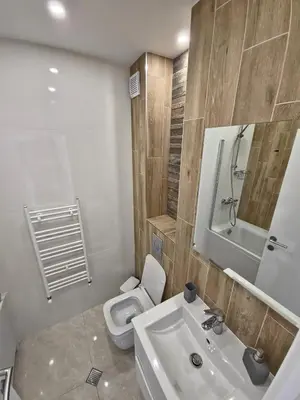 a bathroom with a white toilet and a sink at The View Sofia in Sofia