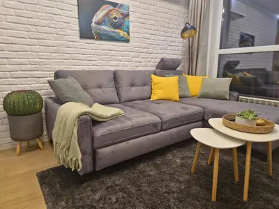 a living room with a couch and a table at The View Sofia in Sofia