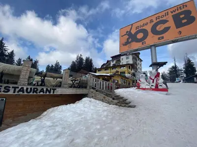 a sign in the snow in front of a ski resort at Castle Inn Pamporovo in Pamporovo