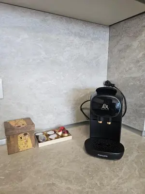 a coffee maker sitting on a counter next to a box of cookies at Stylish and Modern 1bdrm apt free private parking in Sofia