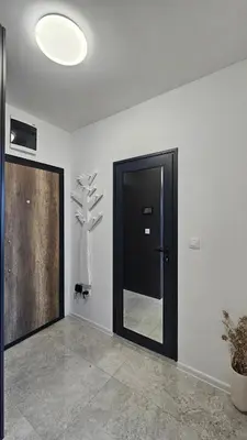 a room with a black door and a cross on the wall at Stylish and Modern 1bdrm apt free private parking in Sofia
