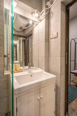 a bathroom with a sink and a mirror at Stylish 2 BDRM Apt at NDK in Sofia