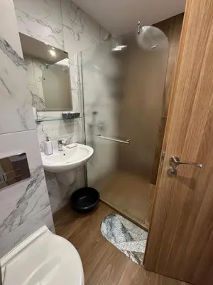 a bathroom with a toilet and a sink and a shower at Borovetz Gardens MVS Apart E28 in Borovets