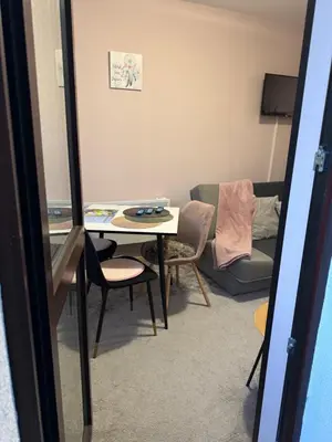 a living room with a table and a couch at Borovetz Gardens MVS Apart E28 in Borovets