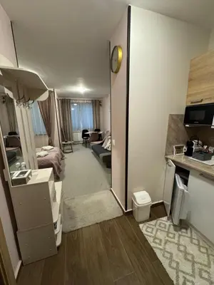 a hotel room with a kitchen and a living room at Borovetz Gardens MVS Apart E28 in Borovets