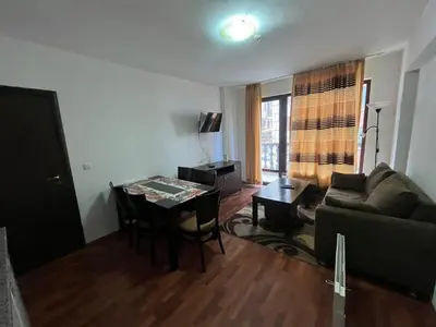 a living room with a couch and a table at Balkan Heights Apartment in Bansko