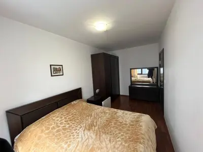 a bedroom with a bed and a mirror in it at Balkan Heights Apartment in Bansko
