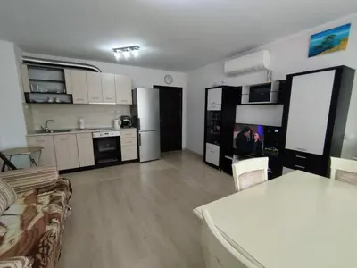 a kitchen and living room with a couch and a table at Апартамент Сандански Център in Sandanski