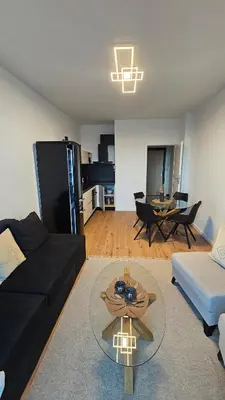 a living room with a couch and a table at Cozy Urban Heaven with Dedicated Parking Spot in Sofia