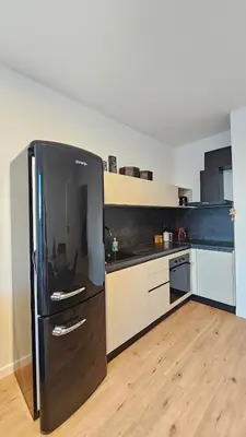 a kitchen with a black refrigerator in a room at Cozy Urban Heaven with Dedicated Parking Spot in Sofia