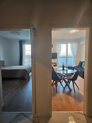 a living room with a bed and a table and chairs at Cozy Urban Heaven with Dedicated Parking Spot in Sofia