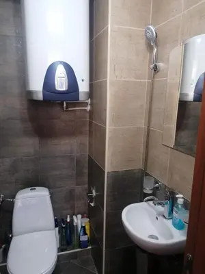 a small bathroom with a toilet and a sink at ИН Хоум Комфорт in Borovets