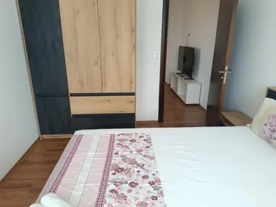 a bedroom with a bed and a door with a rug at Two-bedroom Apartment Lauta 28 in Plovdiv