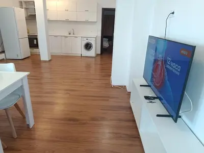 a living room with a tv on a white cabinet at Two-bedroom Apartment Lauta 28 in Plovdiv