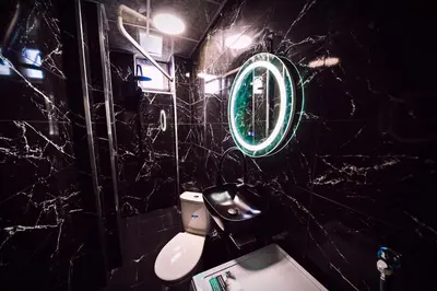 a bathroom with a white toilet and a mirror at Апартамент Япония in Blagoevgrad