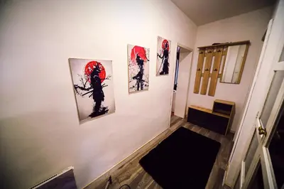 a hallway with three paintings on a wall at Апартамент Япония in Blagoevgrad