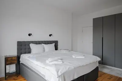 a bedroom with a large bed with white sheets at Luminous Central Retreat Spacious 2BD Apartment by Flat Mаnager in Sofia