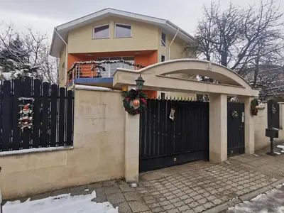 a house with a black fence and a gate at Apartment Tinka in Sofia