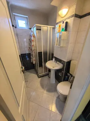a bathroom with a toilet and a shower and a sink at Apartment Tinka in Sofia