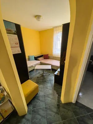 a living room with yellow walls and a couch at Apartment Tinka in Sofia