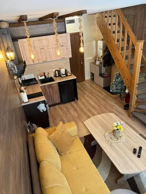 a living room with a couch and a table at From Sunrise to Sunset at Oak Residence Smolyan in Smolyan