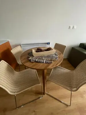 a wooden table with chairs and a couch at The New Inn in Bansko