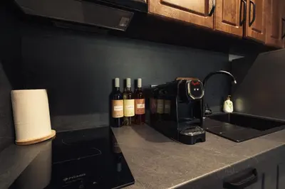 three bottles of wine sitting on a kitchen counter at Mirror Lake Studio in Samokov