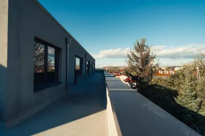 a building with a row of windows on the side of it at Rila Family Haven in Samokov