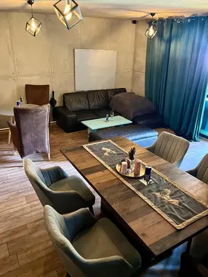 a living room with a wooden table and chairs at Quattro Malyovitsa- Мальовица in Govedartsi