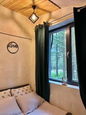 a bedroom with a window and a bed in a trailer at Quattro Malyovitsa- Мальовица in Govedartsi
