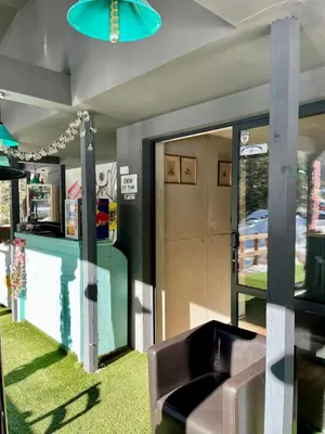 a lobby with a couch and a glass door at Quattro Malyovitsa- Мальовица in Govedartsi