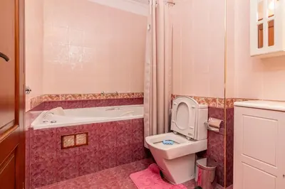 a bathroom with a toilet and a tub and a sink at Къща за гости Карлък in Smolyan