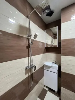 a bathroom with a shower and a toilet and a sink at BoxRoom1 in Kyustendil