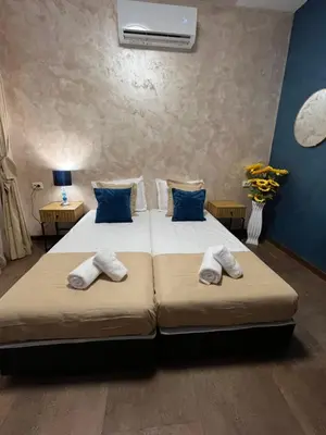 a bedroom with two beds with towels on them at BoxRoom1 in Kyustendil