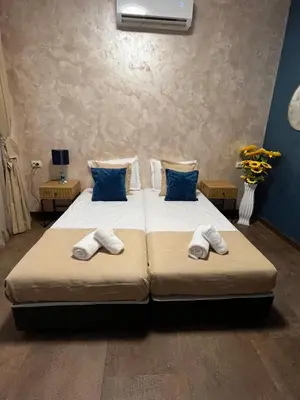 a bedroom with two beds with towels on them at BoxRoom1 in Kyustendil