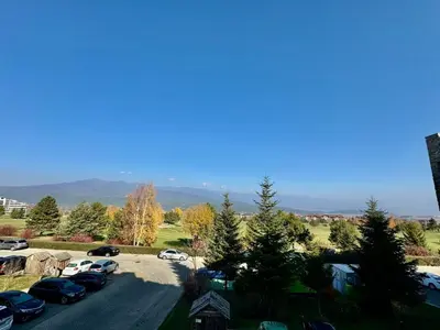 an aerial view of a parking lot with cars parked at Pirin Golf View Apartment Bansko in Bansko
