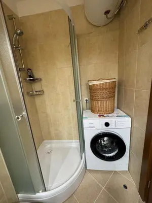 a bathroom with a washing machine and a washer at Pirin Golf View Apartment Bansko in Bansko