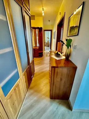 a hallway with a wooden desk and a door at Pirin Golf View Apartment Bansko in Bansko