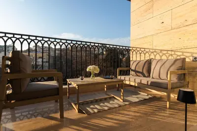 two chairs and a coffee table on a balcony at Simaya, your home in the heart of Sandanski in Sandanski