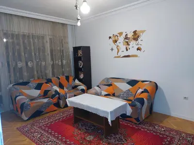 a living room with two couches and a table at апартамент У дома in Plovdiv