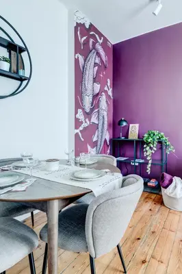 a dining room with purple walls and a table and chairs at Cozy Bright Space in the Heart of Women's Market in Sofia
