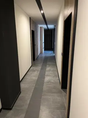 a hallway of an office building with a long corridor at Comfort Airport Metro Suite in Sofia
